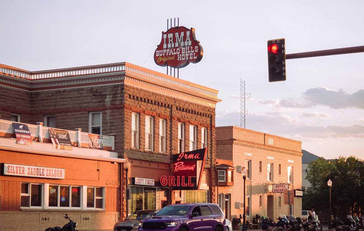 Things to Do in Cody Wyoming: Top 10 Guide to the Rodeo Capital of the World 4 Historic Irma Hotel and Buffalo Bills Original Hotel neon sign in downtown Cody Wyoming at sunset