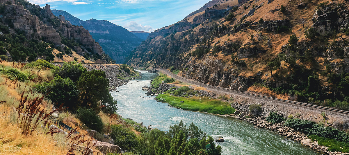 Things to Do in Cody Wyoming: Top 10 Guide to the Rodeo Capital of the World 7 Shoshone River flowing through the rocky canyon near Cody Wyoming with railroad tracks along the bank
