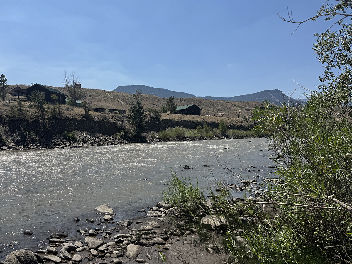 Yellowstone Group Camping: Why Old Faithful RV Park Is Perfect for Your Next Reunion or Rally 4 North Fork Shoshone River with cabins and mountains in the background near Old Faithful RV Park
