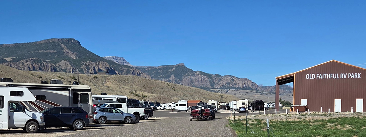 Yellowstone Group Camping: Why Old Faithful RV Park Is Perfect for Your Next Reunion or Rally 3 RVs and motorcycles parked at Old Faithful RV Park with mountain views