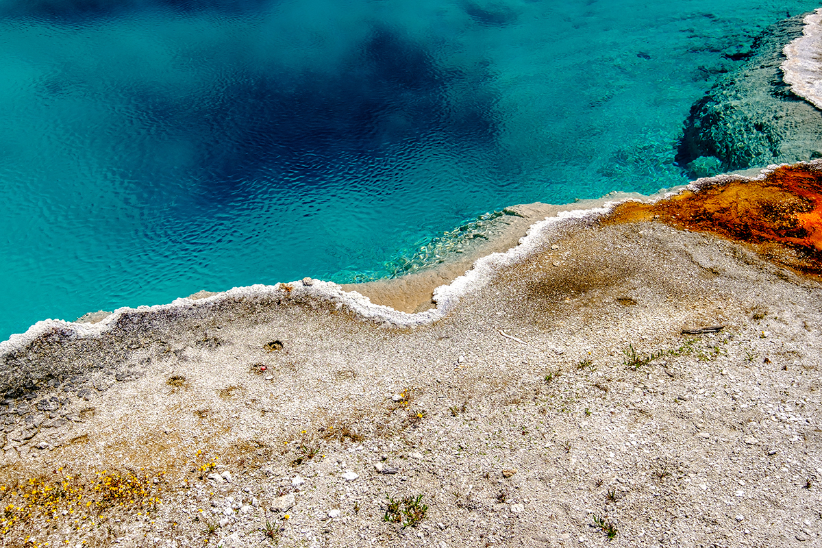 Yellowstone in September: Why It Might Be the Best Month to Visit 3 Turquoise blue thermal hot spring with orange mineral edges in Yellowstone National Park