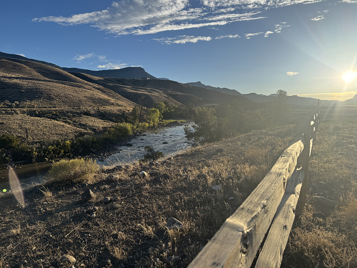 Still Time This Season: Why Now Is a Great Time for a Late Season Yellowstone Trip 5 North Fork Shoshone River glowing in golden evening light near a wooden fence