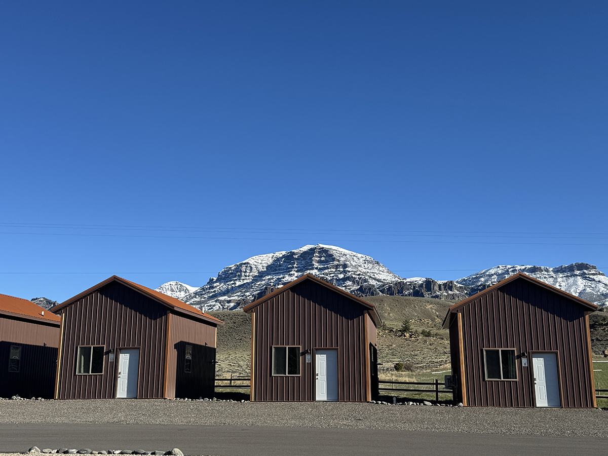 Thank You for an Amazing 2026 Season at Old Faithful RV Park 7 Three cabins with a snow capped mountain behind them at Old Faithful RV Park