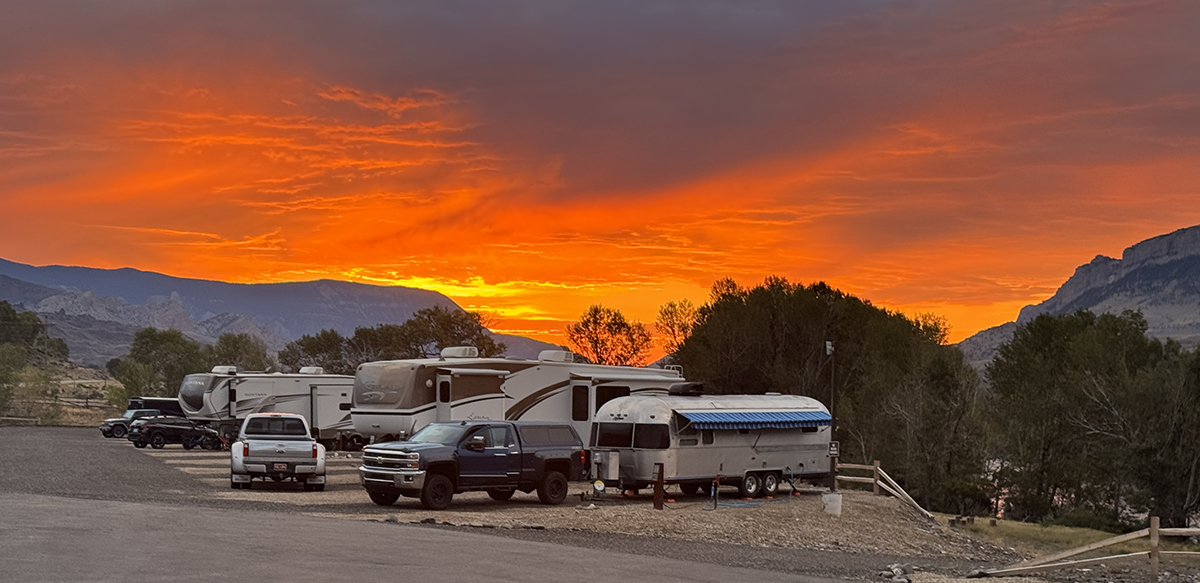 Thank You for an Amazing 2026 Season at Old Faithful RV Park 2 Vivid orange sunset over RVs and an Airstream parked at Old Faithful RV Park 2026 Season