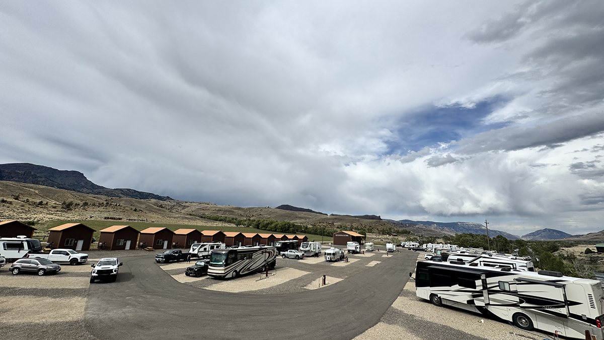Thank You for an Amazing 2026 Season at Old Faithful RV Park 6 Wide view of Old Faithful RV Park with cabins and RVs under a dramatic cloudy sky RV Park Hiring 2027