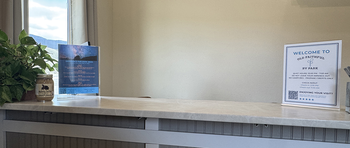 Camp Host Jobs Near Yellowstone: What Camp Hosting at Old Faithful RV Park Looks Like 10 Front office counter with a welcome sign, where office help is a camp host job in Cody Wyoming
