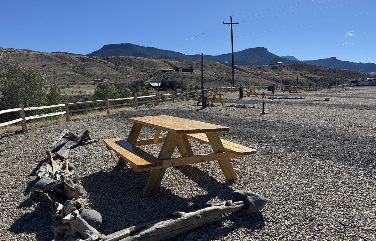 Camp Host Jobs Near Yellowstone: What Camp Hosting at Old Faithful RV Park Looks Like 9 New wooden picnic table with a driftwood border and mountains behind, a maintenance project for workamping jobs Wyoming